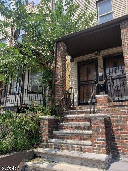 view of exterior entry featuring a porch