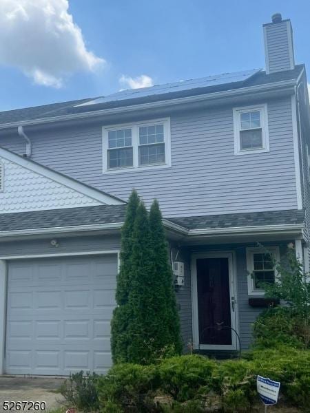 1 Regency Dr, Mount Holly Twp, NJ 08060 - view of front of house with a shingled roof, a chimney, and an attached garage