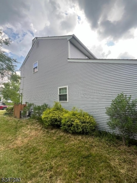 view of side of home with a lawn