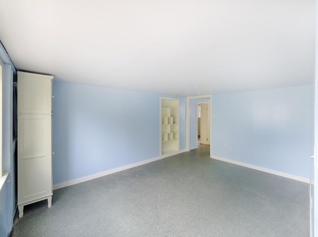 201 Lows Hollow Rd, Lopatcong Twp, NJ 08886 - spare room with built in shelves, baseboards, and speckled floor
