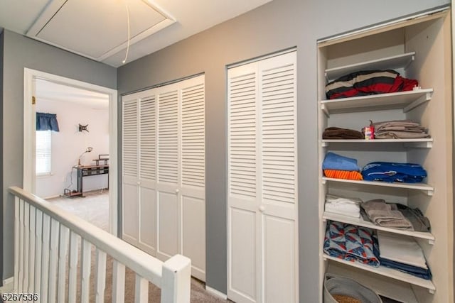 hallway featuring attic access