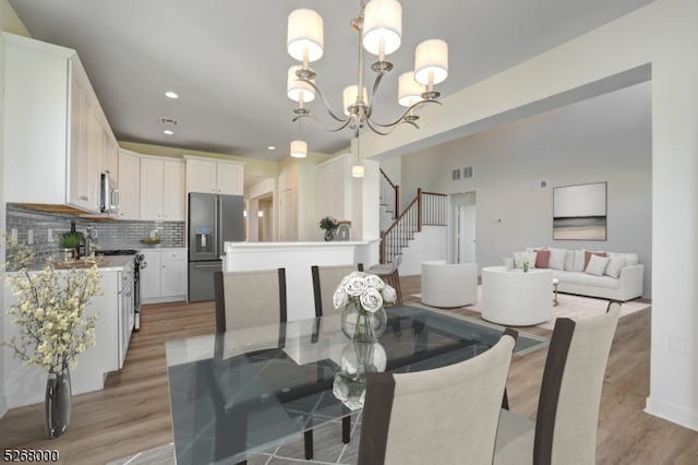 dining space featuring a notable chandelier and light hardwood / wood-style floors