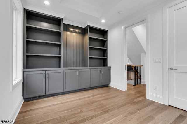 interior space with light hardwood / wood-style flooring and ornamental molding