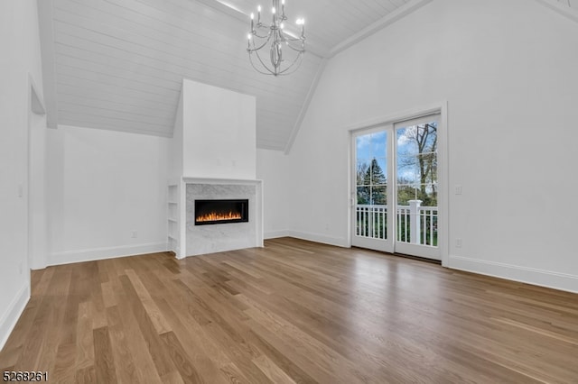 unfurnished living room with wood-type flooring, high vaulted ceiling, a chandelier, and beamed ceiling