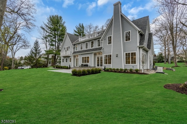 rear view of property with a yard