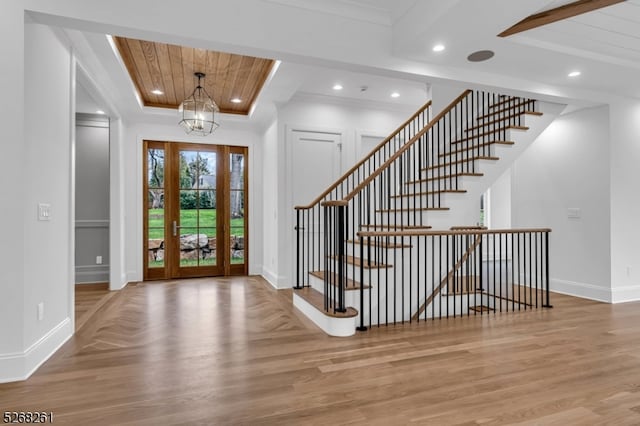 entrance foyer featuring ornamental molding and light wood-type flooring