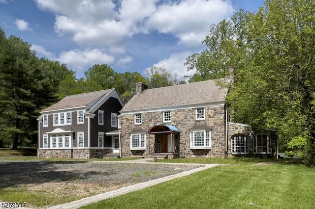 colonial inspired home with a front yard