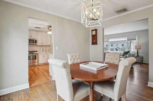 dining space with a baseboard radiator, light wood-style flooring, visible vents, and ornamental molding