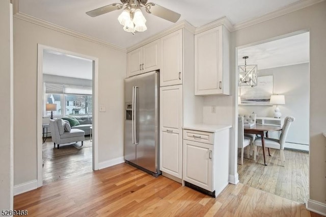 kitchen with light wood-type flooring, baseboard heating, stainless steel refrigerator with ice dispenser, and crown molding