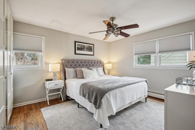 bedroom with baseboards, ceiling fan, light wood finished floors, and baseboard heating