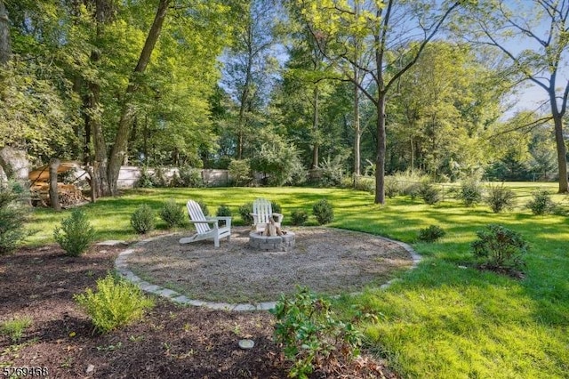 view of yard featuring a fire pit and fence