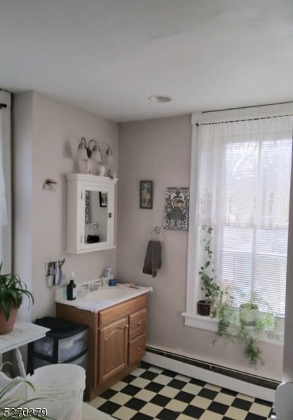 bathroom with vanity, tile patterned floors, and a baseboard heating unit