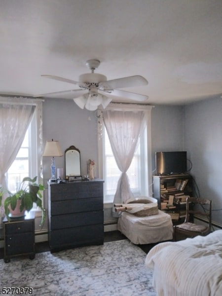 bedroom featuring a baseboard radiator and ceiling fan