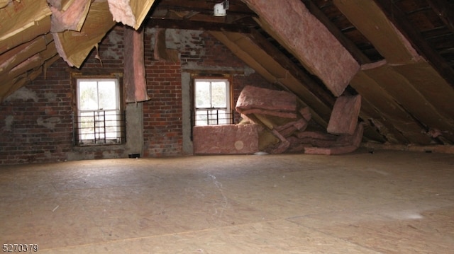 attic featuring a healthy amount of sunlight