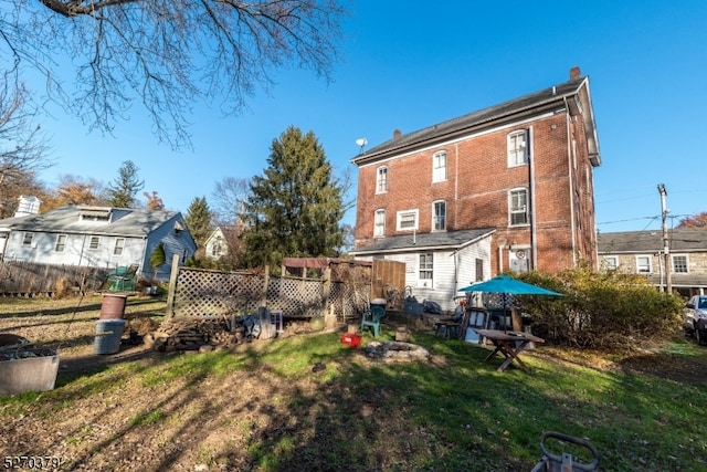 rear view of property with a lawn