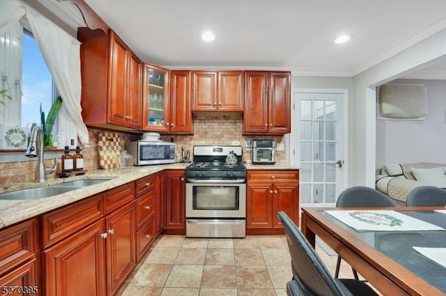 kitchen with decorative backsplash, sink, stainless steel appliances, and ornamental molding