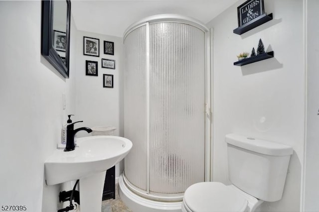 bathroom featuring sink, toilet, and walk in shower