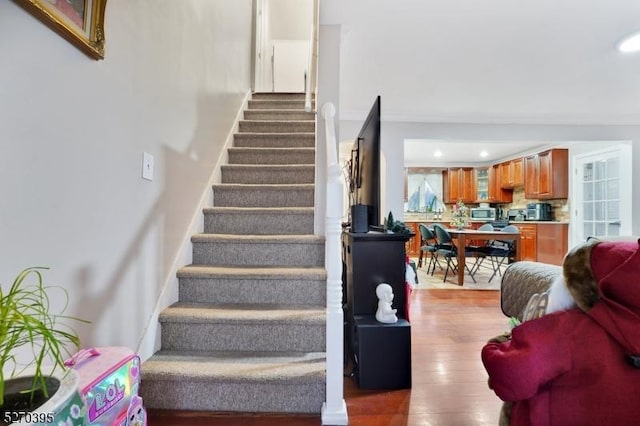 staircase with wood-type flooring