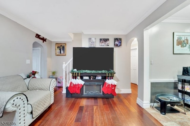 living room with crown molding and hardwood / wood-style flooring