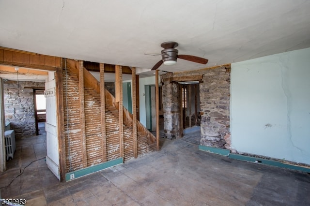 spare room with radiator heating unit and ceiling fan
