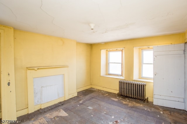 unfurnished living room featuring radiator
