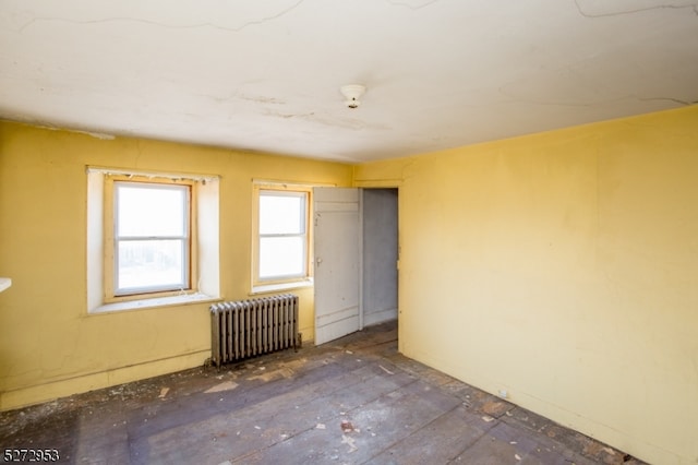 unfurnished room featuring radiator