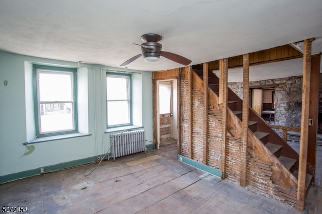 misc room featuring radiator heating unit, ceiling fan, and hardwood / wood-style floors