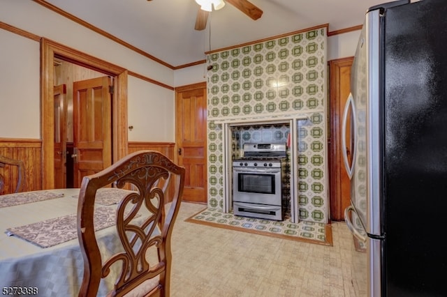 kitchen with appliances with stainless steel finishes, ceiling fan, and ornamental molding