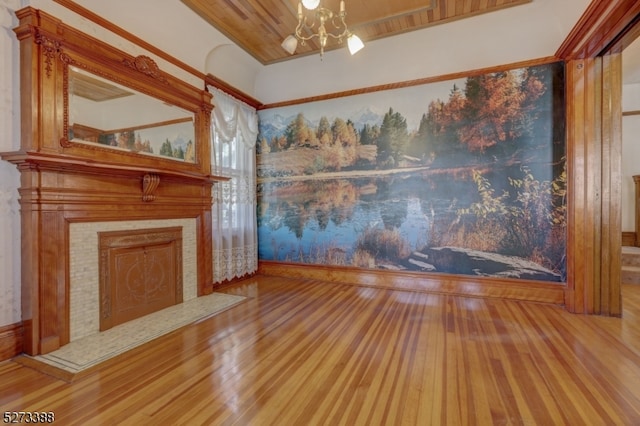 unfurnished living room featuring a brick fireplace, wood ceiling, an inviting chandelier, and light wood-type flooring