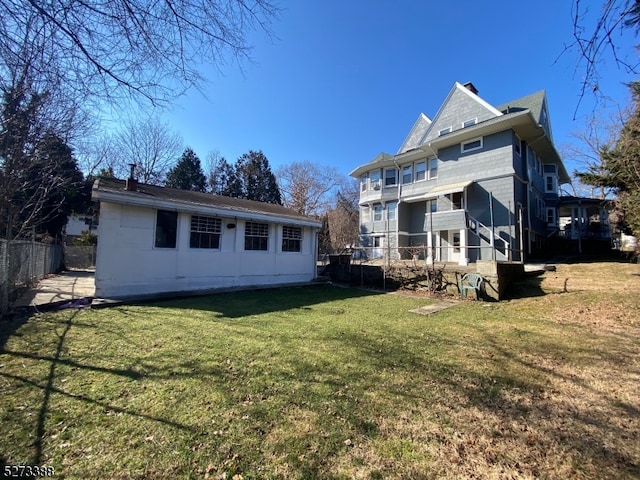 back of property featuring a lawn