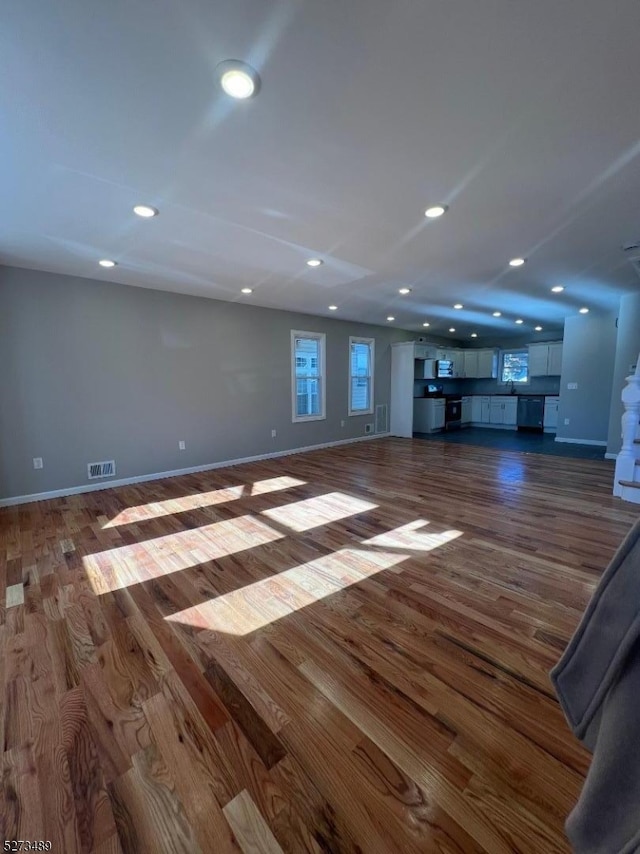 unfurnished living room featuring dark hardwood / wood-style flooring