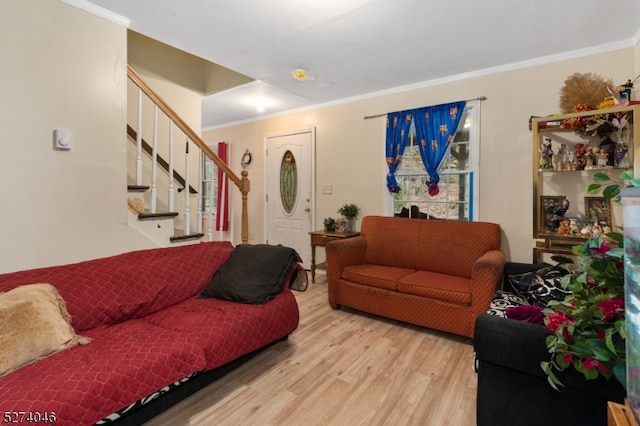 living room featuring light hardwood / wood-style flooring and ornamental molding