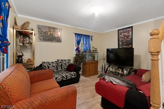 living room with ornamental molding and light wood-type flooring