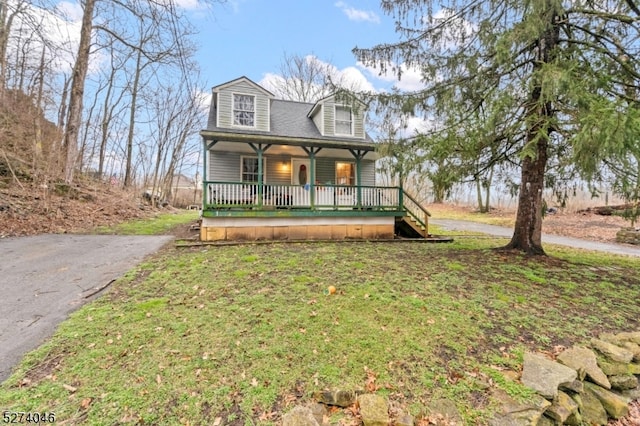 cape cod-style house featuring a front lawn and covered porch