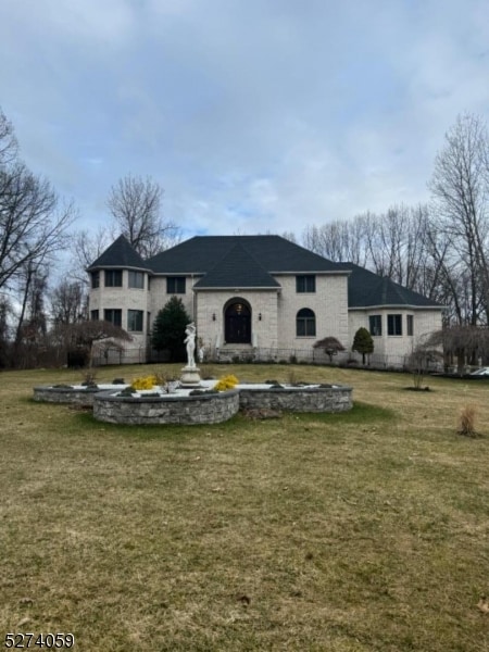 rear view of house with a yard