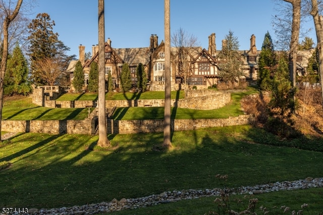 view of home's community with a lawn