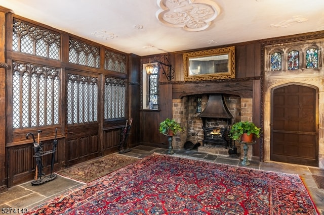 foyer with a healthy amount of sunlight and wooden walls