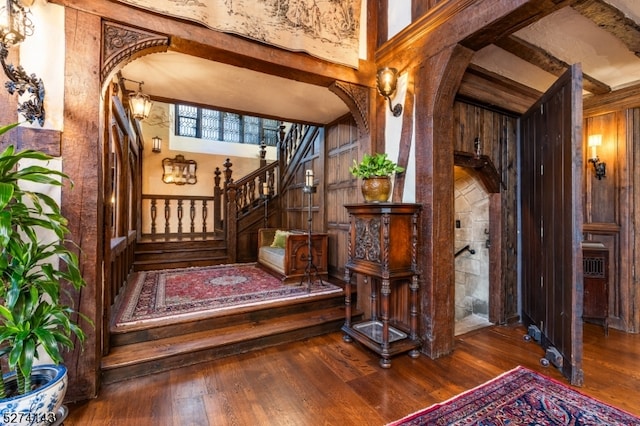 interior space featuring dark wood-type flooring, a high ceiling, and beam ceiling