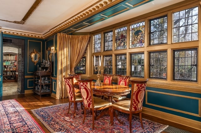 dining space with dark hardwood / wood-style floors and crown molding