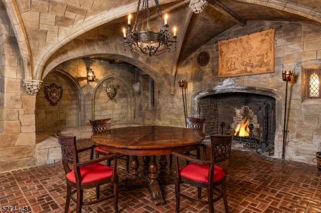 wine area with lofted ceiling and a notable chandelier