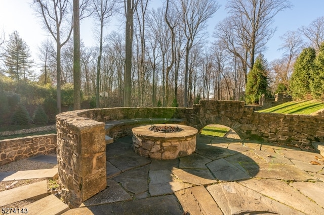 view of patio / terrace with an outdoor fire pit