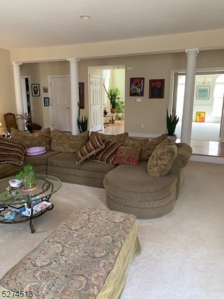 living room with decorative columns and carpet floors