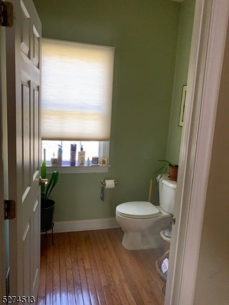 bathroom featuring hardwood / wood-style flooring and toilet