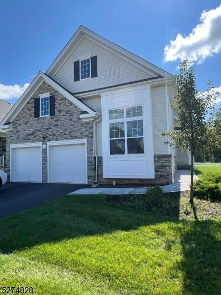 view of front of house with a garage and a front lawn