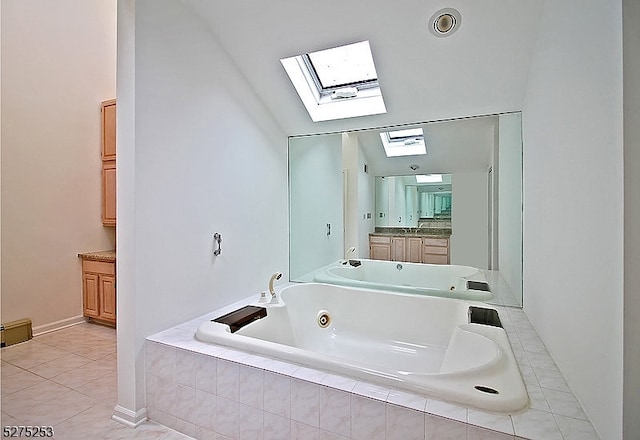 bathroom featuring lofted ceiling with skylight, vanity, and tile floors