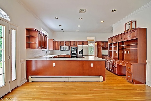 kitchen with appliances with stainless steel finishes, baseboard heating, crown molding, tasteful backsplash, and light hardwood / wood-style flooring