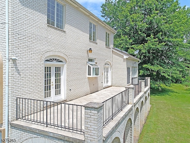 exterior space with a yard and french doors