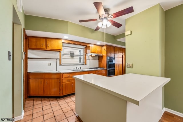 kitchen featuring stainless steel gas cooktop, ceiling fan, light tile floors, sink, and double oven