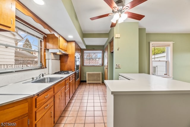 kitchen with ceiling fan, sink, appliances with stainless steel finishes, and light tile flooring