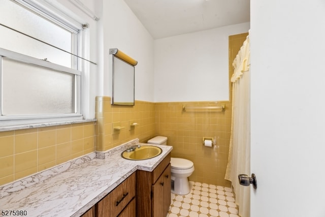 bathroom with tile walls, tile floors, backsplash, toilet, and vanity